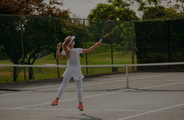 Tennis player jumping to hit the ball